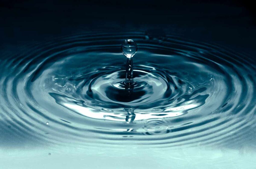 Closeup of a drop of water and the ripples it creates